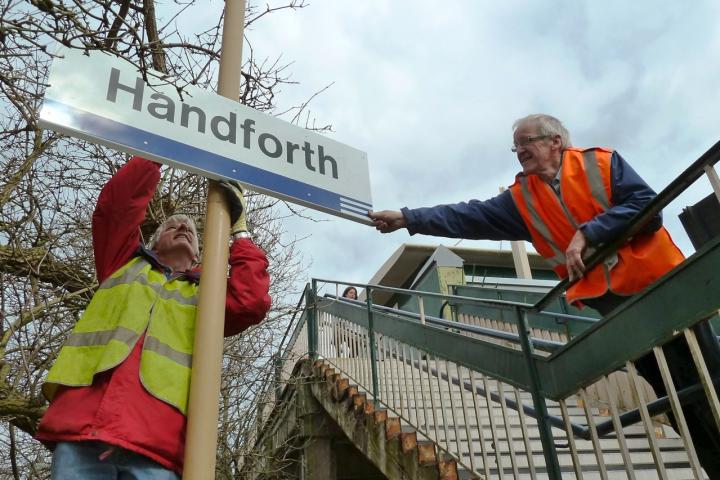 Handforth stationbigtidyup 12 March2011 Erecting Sign