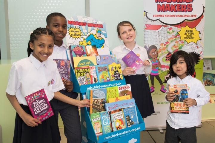 SRC 2018 - four kids 2 with banner and book display