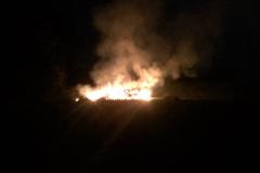 Crew tackles large wood pile fire