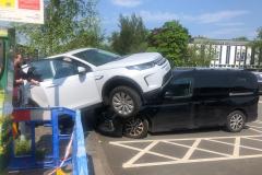 Driver loses control and mounts parked vehicle in supermarket car park