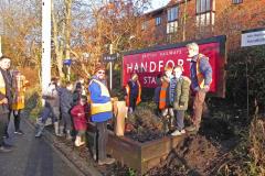 Schoolchildren plant bulbs for a springtime floral display