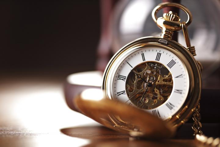 Gold pocket watch and hourglass