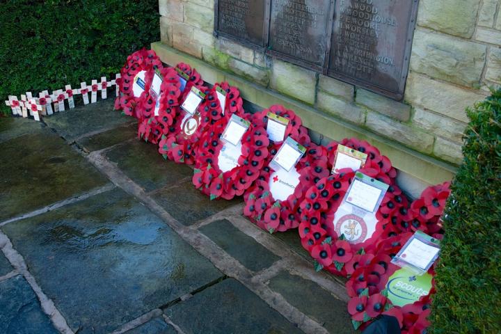 Wrreaths and Crosses at the foot og the memorial stone