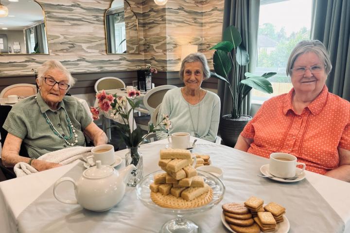 Wilmslow Manor residents celebrate National Biscuit Day. L TO R Joyce Fletcher, 97, Vikki Bacon, 78, and Rosemary Houghton, 76.