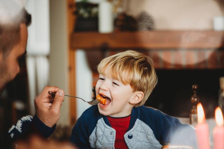 Father feeding his son